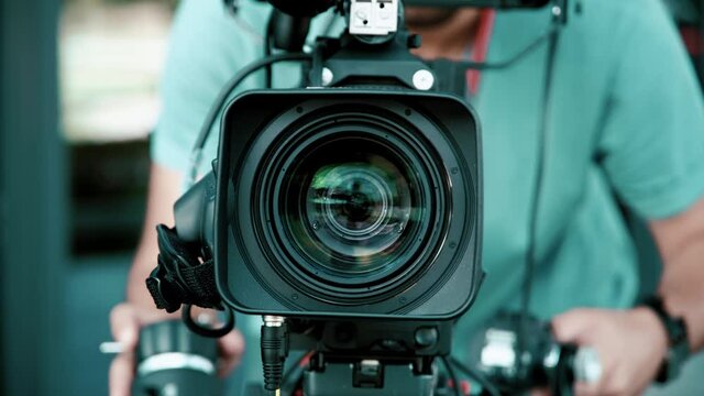 Professional shot of young cameraman shooting a scene