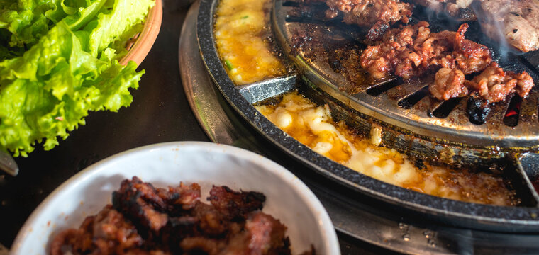 Closeup of Samgyeopsal, grilled cheese and lettuce. Korean cuisine.