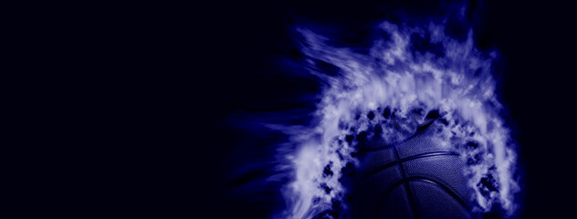 Closeup detail of basketball ball texture background. Basketball Ball on Fire. Team sport concept.  Sports modern banner. Blue color filter