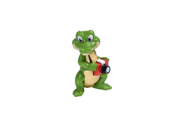 Crocodile toy figure with camera on white background under clipping