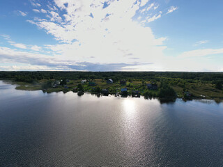 a panoramic view of the green islands on the lake with ships with ancient architectural buildings filmed from a drone