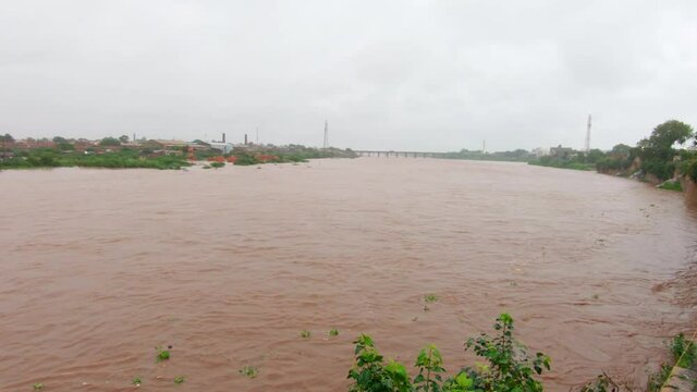 Wankaner, India - circa 2020: View of the flooding macchu river during the extreme monsoon rain at Wankaner, Gujarat, India
