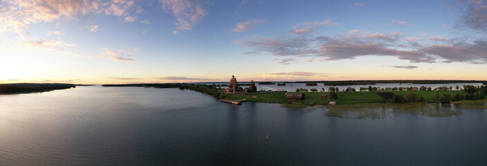 a panoramic view of the green islands on the lake with ships with ancient architectural buildings filmed from a drone