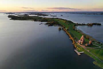 a panoramic view of the green islands on the lake with ships with ancient architectural buildings filmed from a drone