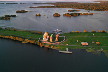 a panoramic view of the green islands on the lake with ships with ancient architectural buildings filmed from a drone