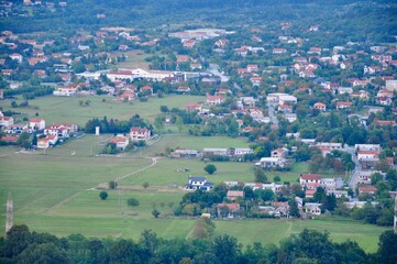 Fototapeta na wymiar aerial view of a village in croatia. Grobnik field panorama and mountains in background. Mountain panorama view of landscape of Grobnik meadow.