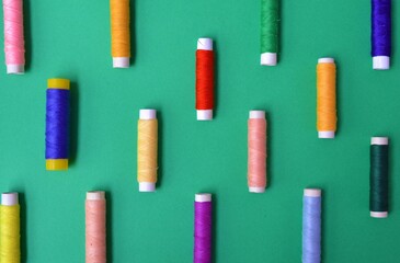 Colorful threads on green background