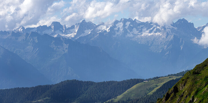 The meadows, the views and the peaks of the orobie alps during a summer afternoon, near the San Marco pass, Lombardy, Italy - June 2020