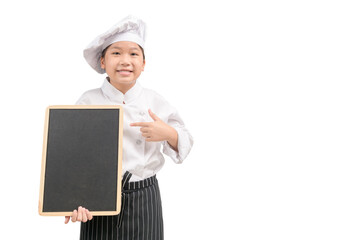 Happy asian girl chef in uniform pointing at blank blackboard isolated