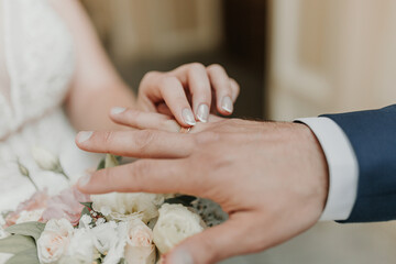 The bride and groom exchange wedding rings.