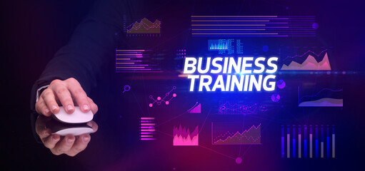 hand holding wireless peripheral with BUSINESS TRAINING inscription, cyber business concept