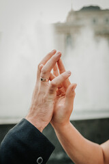 The hands of a man and a woman gently touch each other.