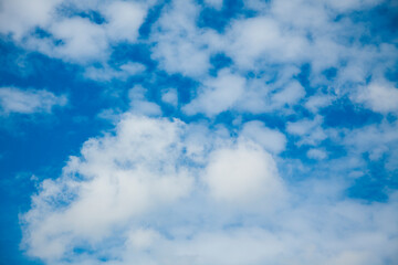 blue and white sky bright Sunny clouds contrasting photo background