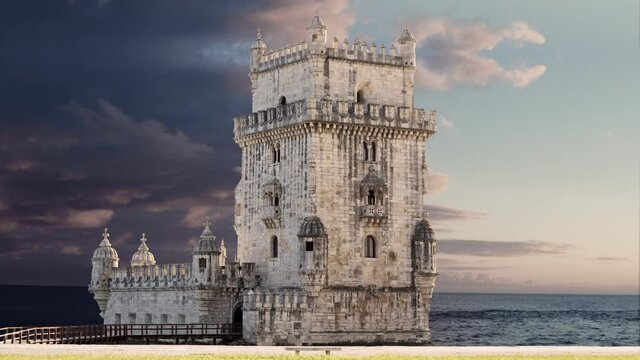 4k close up belem tower at the sunset with sunny sky and some clouds, Lisboa ( Portugal ). Frontal view of tower, Atlantic ocean in background.