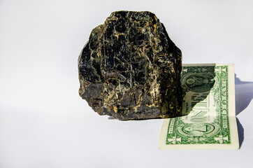 Lump of coal on a dollar bill conceptual photo. Coal demand. The value of coal. One dollar with coal. Growth in demand for coal in the world market. Mineral money