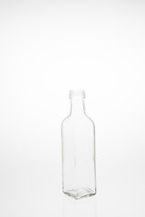 Isolated glass bottle on white background without cap.