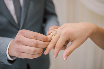 Wedding couple exchanging wedding rings. Wedding rings.