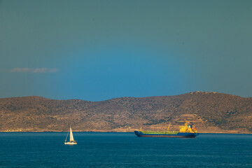 A yatch and a tanker in front of Kea Island