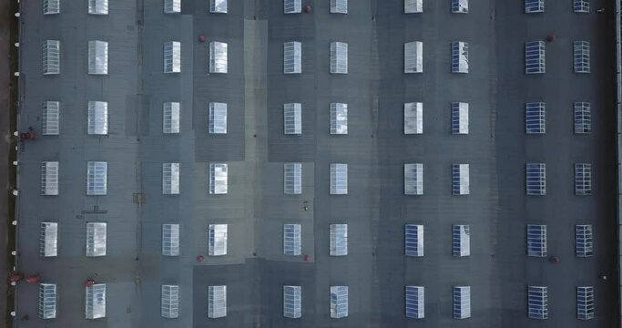 warehouse flight over roof with windows, downward movement decrease