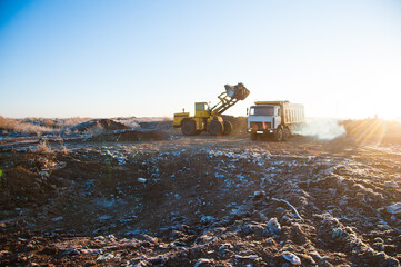 Bulldozer removes a wild dump