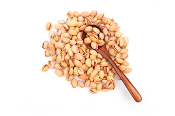 Nuts pistachios in a wooden spoon on a white background. Top view.
