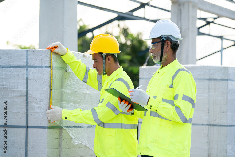 Aufkleber construction engineer team with clipboard checking work with at construction site.