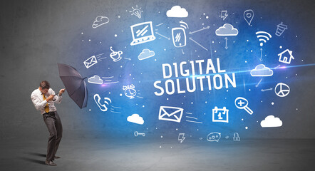 Businessman defending with umbrella from DIGITAL SOLUTION inscription, modern technology concept