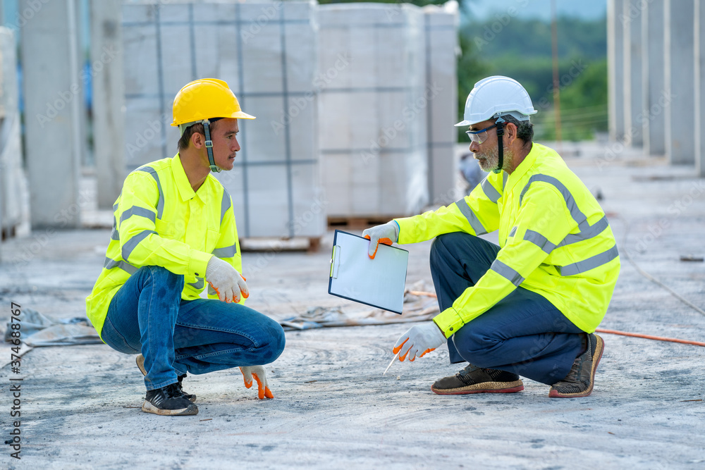 Aufkleber construction engineer team with clipboard checking work with at construction site.