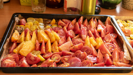 tray with sliced tomatoes, different colors and shapes, autumn harvest