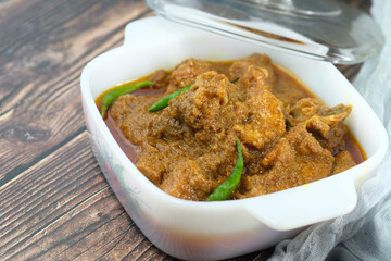 traditional Indian curry lamb masala in a bowl on table 