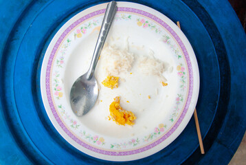 White dirty dish with spoon