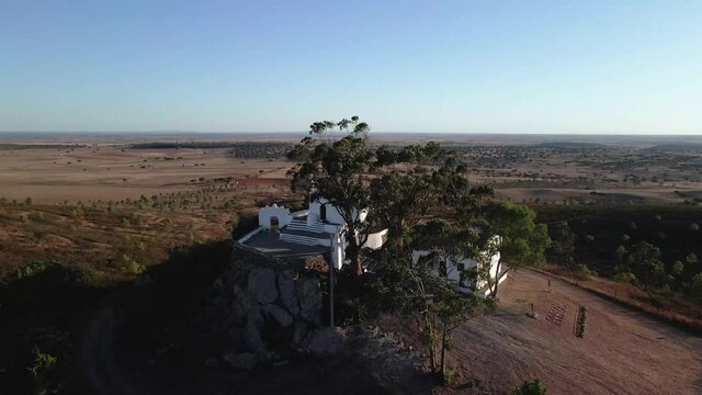 Ermida de Nossa Senhora de Aracelis aerial view, a hermitage and church perched on a Alentejo hill, looking out on beautiful views across the cultivated plateau. Portugal.