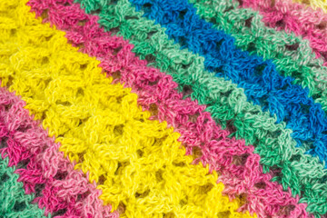 handmade multicolor crochet background in yellow, green and pink with double crochet stitches