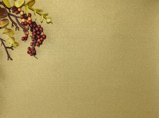 Blank Dark Yellow Background with Berries and Leaves Autumn Colors Green Red Orange and Maroon Fall Foliage with Copyspace for Advertisements and Greeting Cards E-Cards Seasonal Announcement Graphic