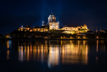 Fototapeta na wymiar Castle Hill of Esztergom basilica night photo. Reflection in water. Stars and light