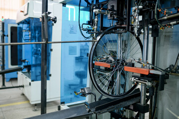 Fototapeta na wymiar Bicycle wheels, assembly line, spokes installation