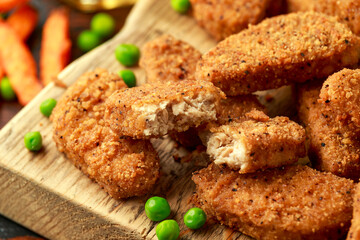 Vegetarian vegan southern style crispy nuggets served with sweet potato chips and beer