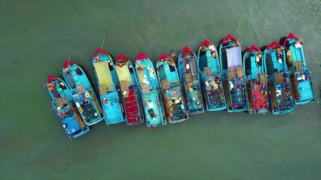 Fishing harbor aerial view, amazing nature background.The color of the water and beautifully bright with traditional blue wooden boats