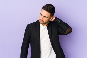 Young caucasian man isolated on purple background having a neck pain due to stress, massaging and touching it with hand.