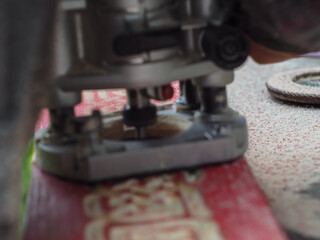 the man handles the product with a hand mill. woodwork.