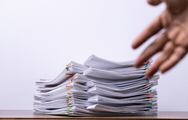 Stack of paper with blured hand, business concept.