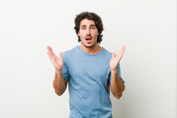 Fototapeta premium Young handsome man against a white background surprised and shocked.