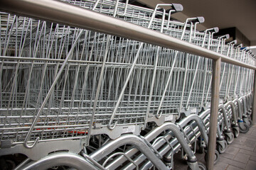 close up into a row of shopping trolleys