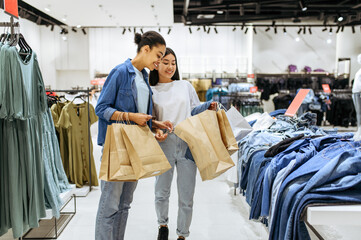 Girlfriends with cardboard bags, clothing store