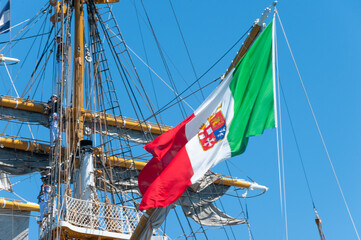 Italian Navy flag waving on the training ship of the Italian Navy "AMERIGO VESPUCCI" in the harbour of Taranto, Italy © bravajulia