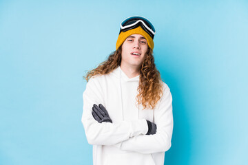 Young caucasian man wearing a ski clothes isolated  laughing and having fun.