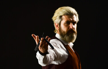 should try this. haircut by hairdresser. Portrait of stylish man beard. holding equipment. Getting perfect shape. getting beard haircut by hairdresser at barbershop. hairdresser or barber scissors