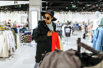 Fashionista choosing clothes in clothing store