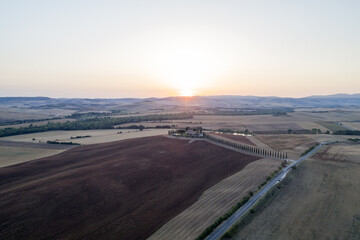 Aerial view of dawn in the valley of the edge, the sun just arose, the countryside in Tuscany