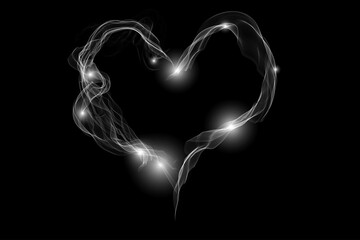 Motion of smoke heart shape isolated on the dark background.